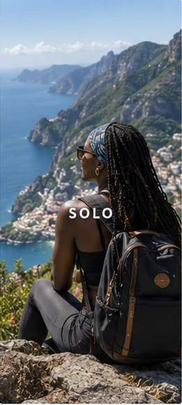 A solo traveller looking across a Mediterranean coastline